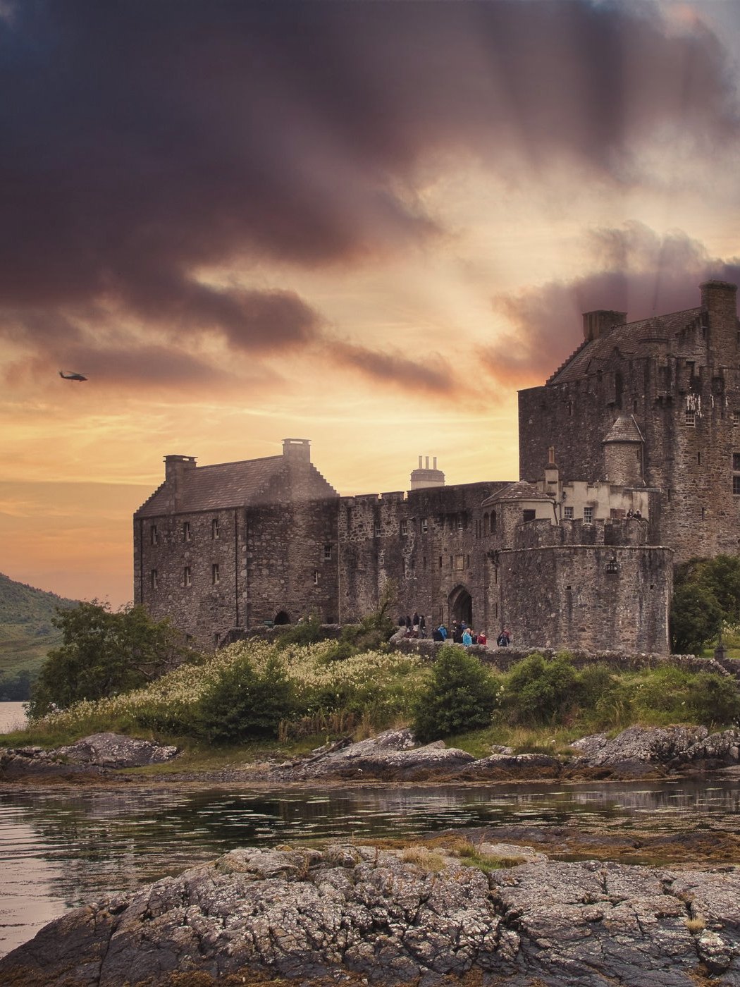 A Scottish castle above the water at dusk