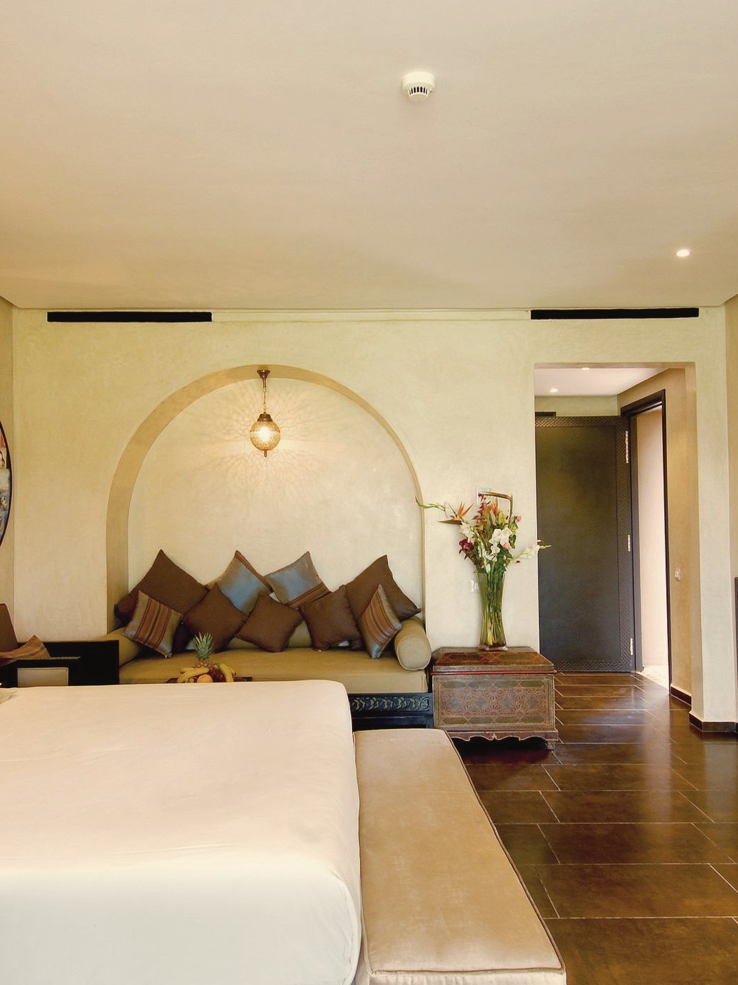 A hotel room with an arched alcove